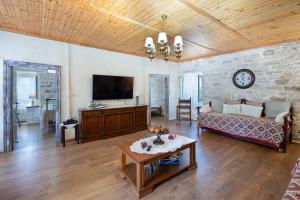 a living room with a couch and a table at Ionian Stone Home with Terrace in Bogdanátika