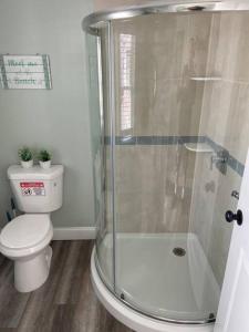 a bathroom with a toilet and a glass shower at 318 E Youngs Ave Unit 8 Salty Shore Retreat Idyllic Studio by the Sea in Wildwood