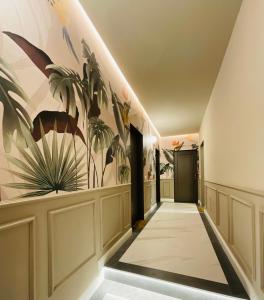 a hallway with a mural of plants on the wall at Apartment Suite - Charlize - in the heart of Milan in Milan