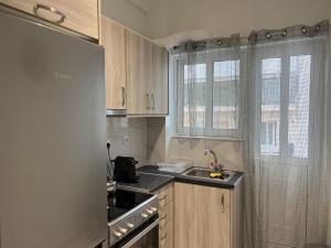 a small kitchen with a sink and a stove at Adelais in Piraeus