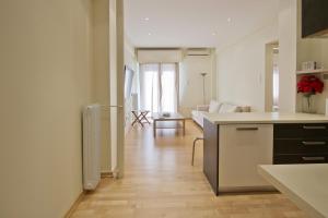 a kitchen and living room with a table and a counter at Lucys Port in Piraeus