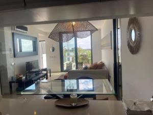 ein Wohnzimmer mit einem Glastisch und einem Sofa in der Unterkunft LUXURY House with Stunning Sea Views - Ses Salines in La Savina