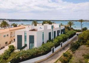 an aerial view of a white building next to the water at LUXURY House with Stunning Sea Views - Ses Salines in La Savina