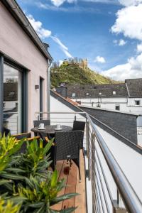 a balcony with chairs and a view of a castle at Ferienwohnungen Assenmacher mit Sauna in Altenahr