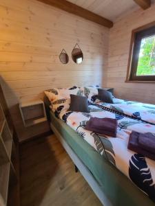 a bedroom with two beds in a log cabin at Leśne Dziady Borsk in Borsk