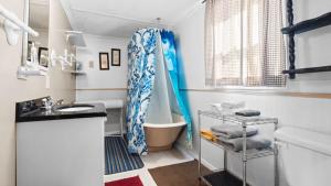 a bathroom with a tub and a shower curtain at Cozy house close to Main St in downtown Leadville! in Leadville