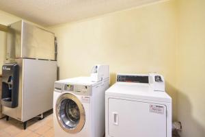 a laundry room with a washer and a refrigerator at Best Western Northgate Inn Pampa in Pampa