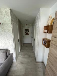 a hallway with white walls and a white door at Jour meilleur à Métabief in Métabief