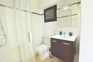 a bathroom with a toilet and a sink and a shower at Apartamentos Arrecife Playa in Arrecife