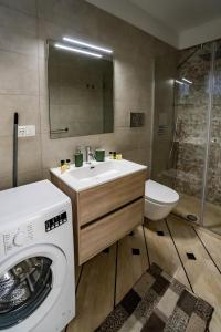 a bathroom with a washing machine and a sink at Appartamenti Petali Di Rosa in Custonaci