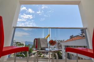 a room with a large window with a table and chairs at BERRY BELLA HOTEL in Marmaris