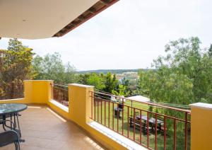 a balcony with a table and chairs and a view at Natural Oasis Villa in Nea Fokea
