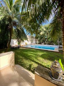 a vase sitting on a bench next to a swimming pool at Beautiful Apartment surrounded by nature w/Pool in Cancún