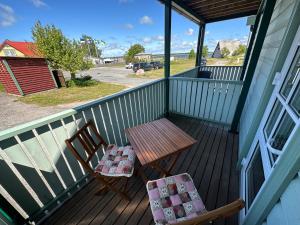 a porch with a table and two chairs on it at Sadama Apartement Haapsalu in Haapsalu