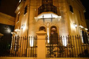 a building with a fence in front of it at Ambit Boulevard Hotel Boutique in Santa Fe