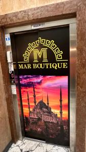 a sign for a men bathroom with a picture of a mosque at Mar Boutique Apartment in Istanbul