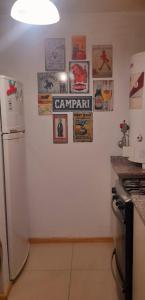 a kitchen with a refrigerator and posters on the wall at Moderno departamento in Godoy Cruz