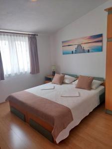 a bedroom with a large bed in a room at Apartment Antonia in Vodice