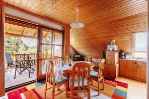 a kitchen and dining room with a table and chairs at Ferienhaus Nora in Sankt Kanzian