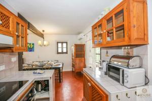 a kitchen with wooden cabinets and a counter top at SANTA URSULA 