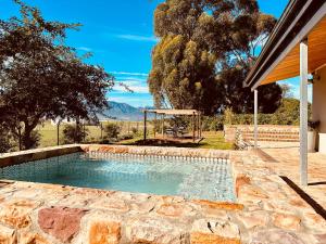 a swimming pool with a playground in a yard at Primo farm in Paarl