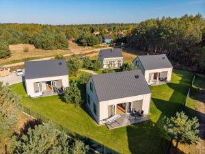 an aerial view of a house with a yard at Domki Sunset Lubiatowo in Lubiatowo