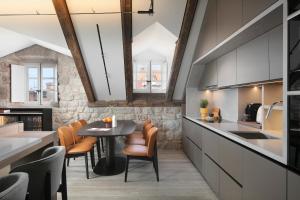 a kitchen with a table and chairs in a room at Villa Lapisa in Dubrovnik