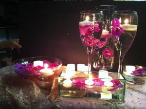 a table with candles and glasses of wine and flowers at Taj Campton Place in San Francisco