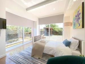 a bedroom with a bed and a large window at Capelas House Family in Capelas