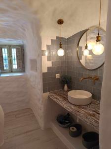 uma casa de banho com um lavatório e um espelho em Cueva OTTO Familiar Privada em Baza