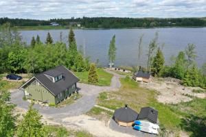 an aerial view of a house next to a lake at Villa Granbacka Raasepori Karjaa Finland in Karjaa