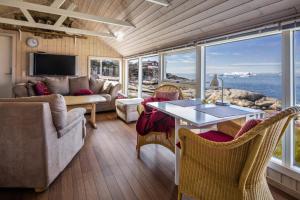 a living room with a view of the ocean at Jomsborg Ilulissat in Ilulissat