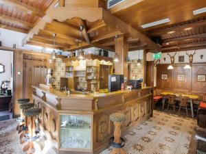 a large room with a bar with a fireplace at Gasthof Wabitsch in Kliening