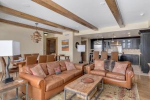 a living room with a couch and a table at Edgemont 2601 - Luxury Ski-in Ski-out Condo in Steamboat Springs