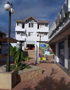 a white building on the side of a street at HOSTAL EDEN in Torotoro