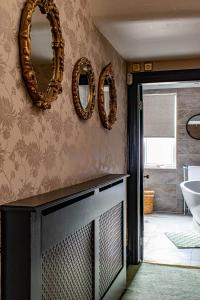 a bathroom with mirrors on the wall and a sink at The Canoeists Hideaway in Seaton Carew