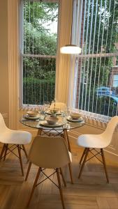 a dining room with a table and chairs and a window at CityGo Apartments Queens in Belfast