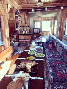 a living room with a table with food on it at Doga ile basbasa Eko yayla in Tonya