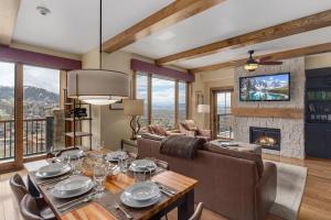 a dining room with a table and a fireplace at Edgemont 2602 - Luxury Ski-in Ski-out Condo in Steamboat Springs