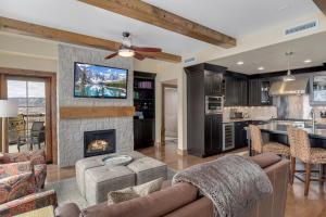 a living room with a couch and a fireplace at Edgemont 2602 - Luxury Ski-in Ski-out Condo in Steamboat Springs