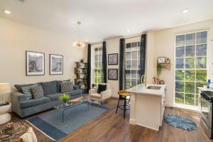a living room with a couch and a table at The Alexandre in New Orleans