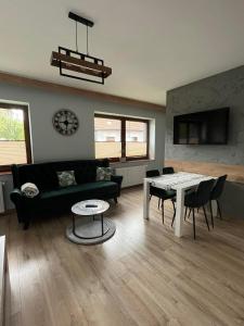 a living room with a couch and a table at Apartamenty Wadowity- Energylandia Zator in Wadowice