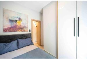 1 dormitorio con 1 cama y una pintura en la pared en ARES - Standard Suite, en Tesalónica