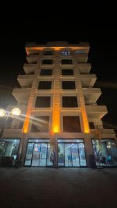 a tall building with a lot of windows at night at Melissa Suite Otel in Trabzon