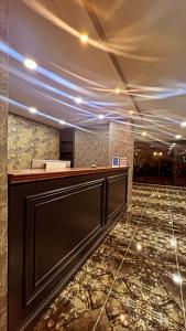 a lobby with a reception desk and a marble floor at Melissa Suite Otel in Trabzon