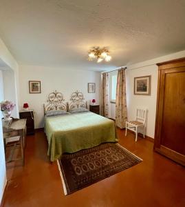 a bedroom with a bed and a table and a chair at Villa Filippo in Cerliano