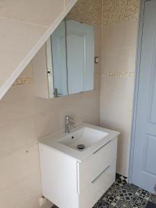 a white bathroom with a sink and a mirror at BELLE MAISON A Ménars in Menars +23 photos