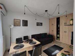 a living room with a table and a couch at Kinizsi Apartman in Miskolc