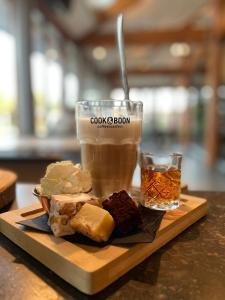 a plate of food and a drink on a table at Nature & golf Villa in Oosterhout