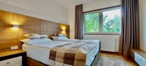 a bedroom with a large bed and a window at Villa Wood & Green SPA in Hadžići +31 photos
